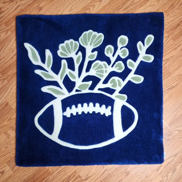 Football and leaves, a hand-tufted rug by Made By Juice