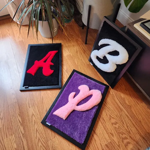 Framed letters, a hand-tufted rug by Made By Juice
